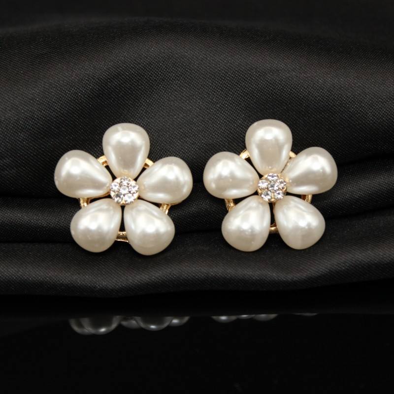 Pair of pearl button a black background