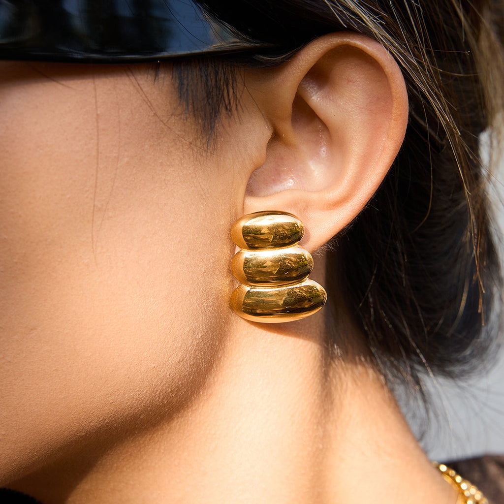 Close-up of a person wearing a gold hoop  Earrings For Women.