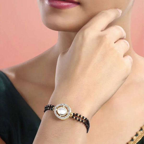 Black beaded bracelet for women with gold circular centerpiece, daily wear bracelet for office and festive stylingd